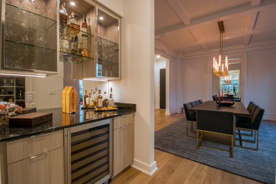 Home bar with glass doors and under-cabinet lighting