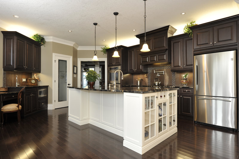Kitchen with white island and dark wood color cabinetry