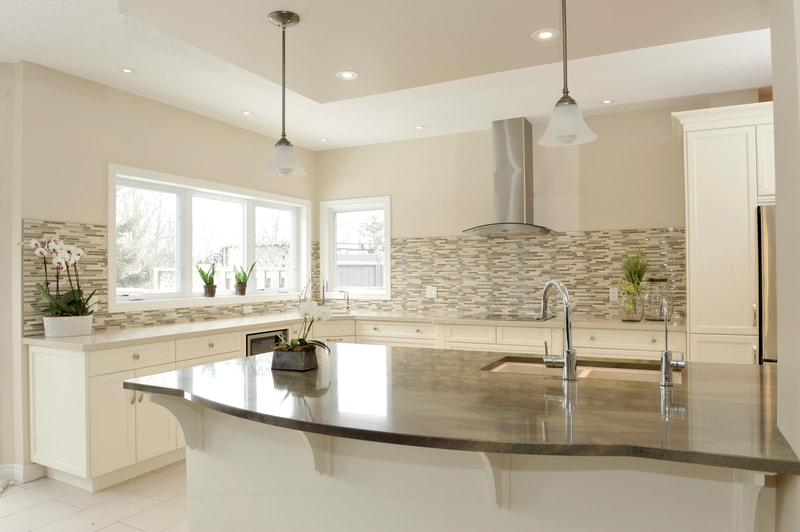 White kitchen with sink island and tile backsplash