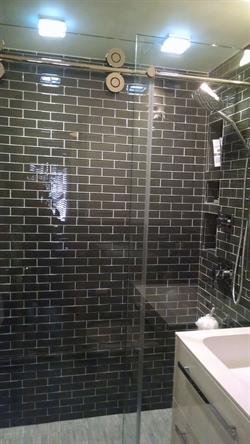 Tiled master bath shower with glass doors