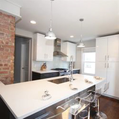 White kitchen with exposed brick
