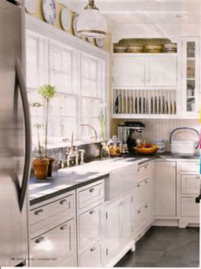 White kitchen with open shelving and stainless steel appliances