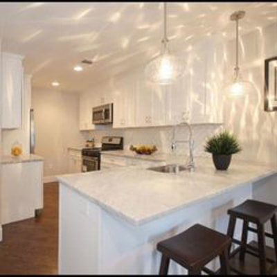 White kitchen with lighting over dining island