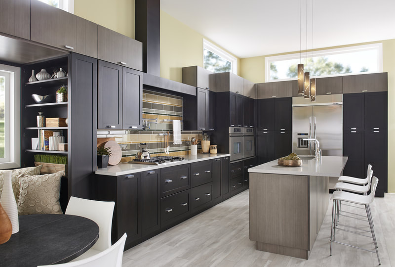 Dark custom kitchen cabinetry with lighter work island