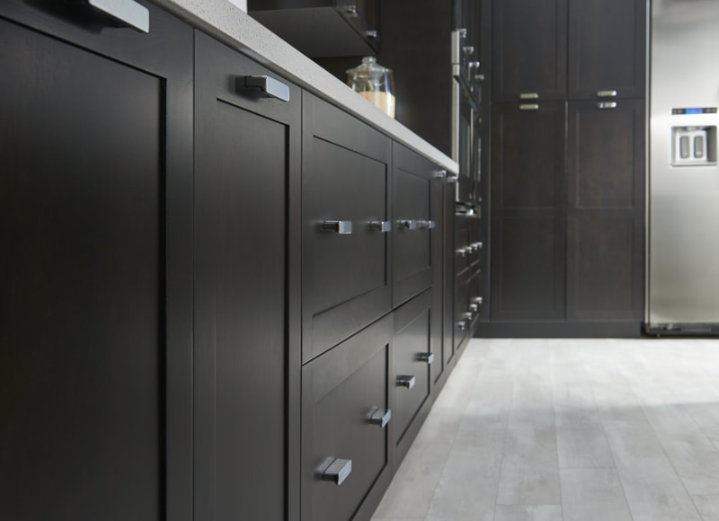 Closeup drawer pulls on dark custom kitchen cabinetry