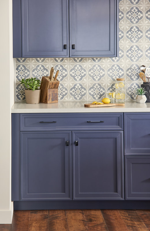 Blue kitchen cabinetry with tile backsplash