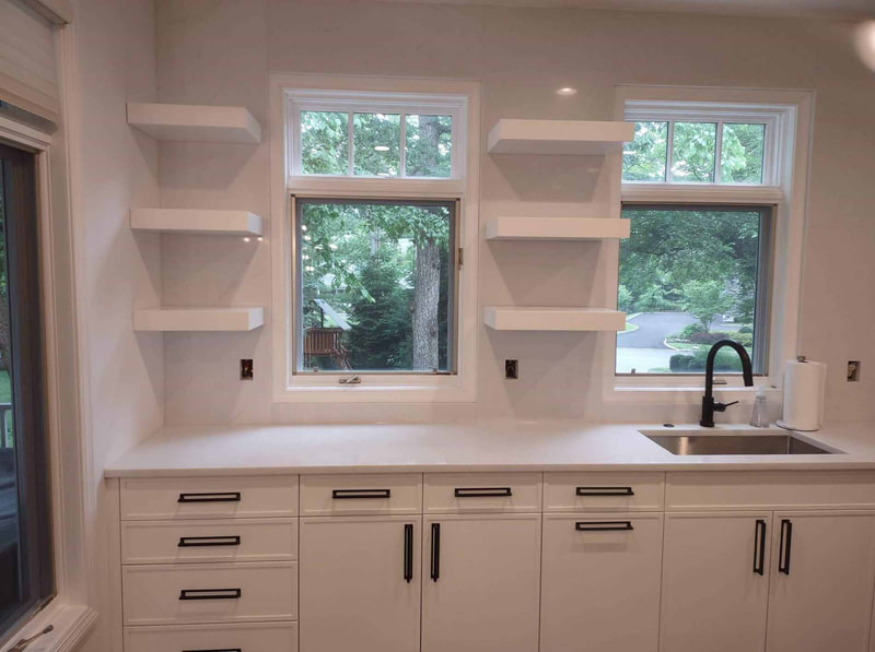 White kitchen with work area near sink and open shelving